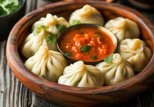 Chicken Momos – Served with Red & Green Chilli Sauce